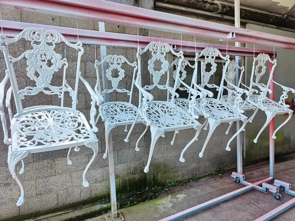 A collection of patio chairs hanging after being sandblasted by Autoblast