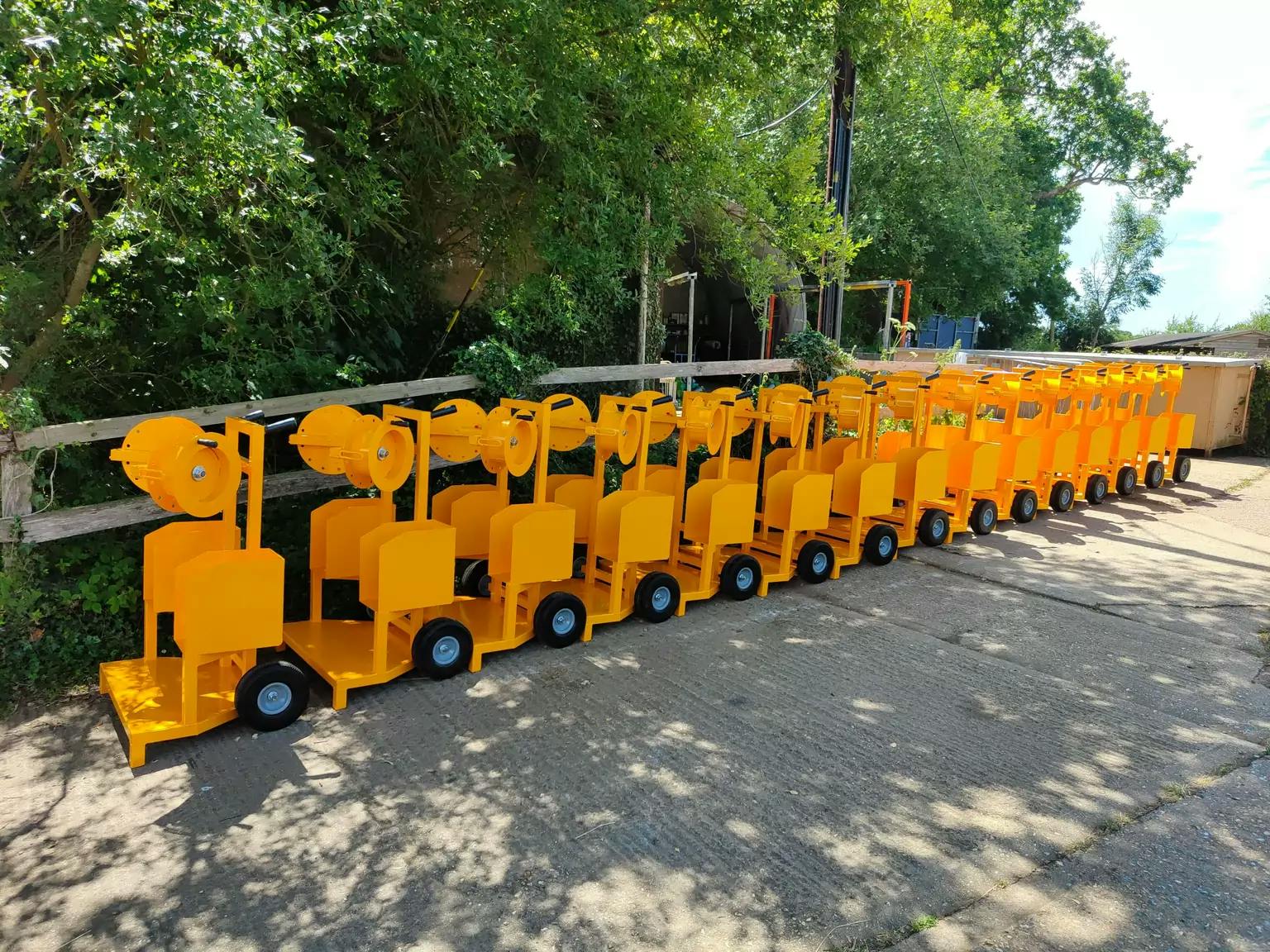 A row of yellow trolleys fabricated by Autoblast